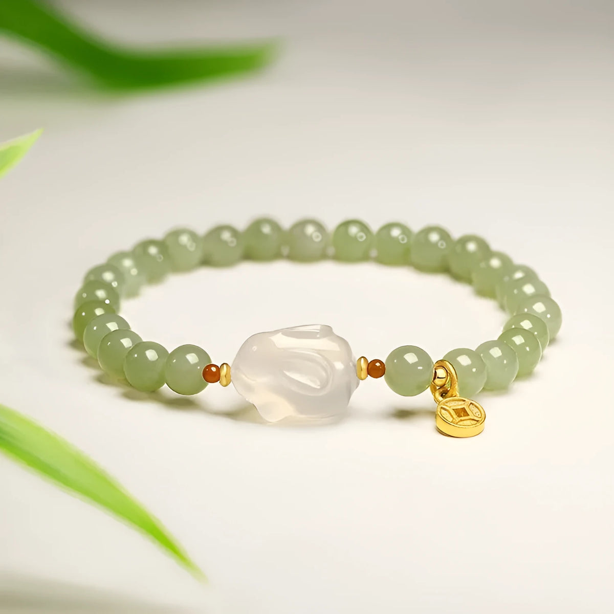 Handmade women's bracelet with a glass rabbit charm on a coloured glaze chain.