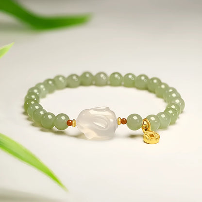 Handmade women's bracelet with a glass rabbit charm on a coloured glaze chain.