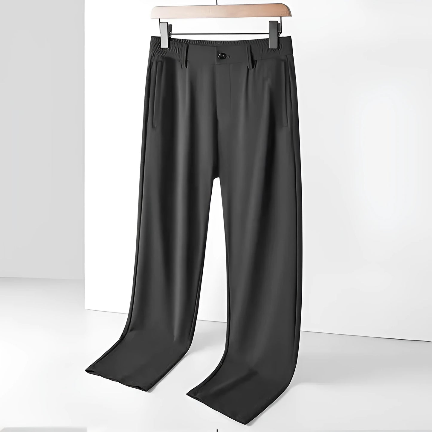 Man wearing black Ice Silk loose-fit casual trousers with an elastic waistband.
