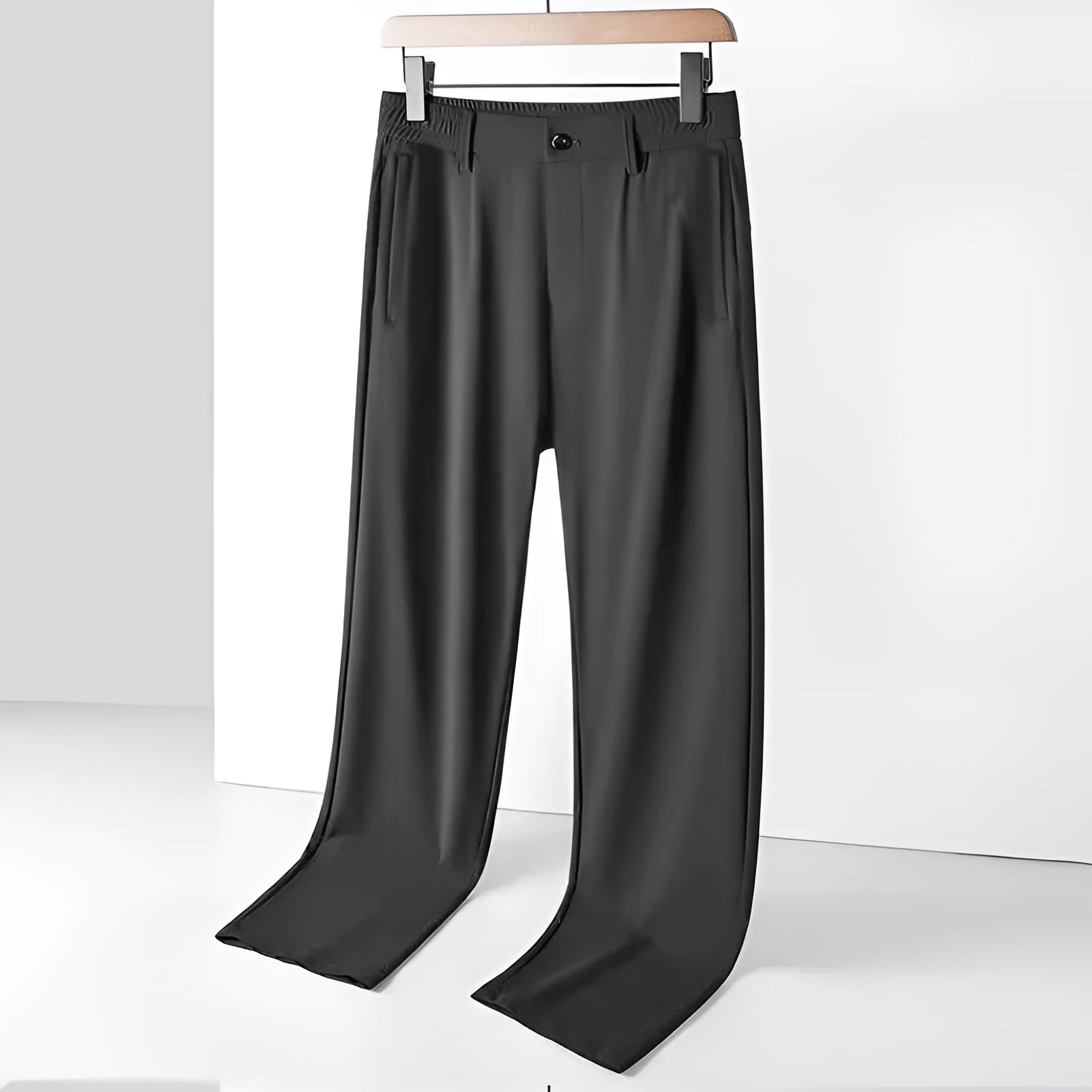 Man wearing black Ice Silk loose-fit casual trousers with an elastic waistband.