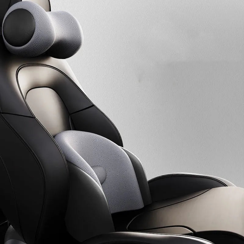 Black car massage cushion with headrest and lumbar support on a car seat, showing wired controller.