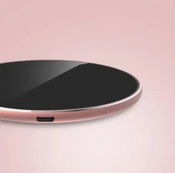 Ultra-thin aluminium wireless charger in rose gold with micro USB port and status light.