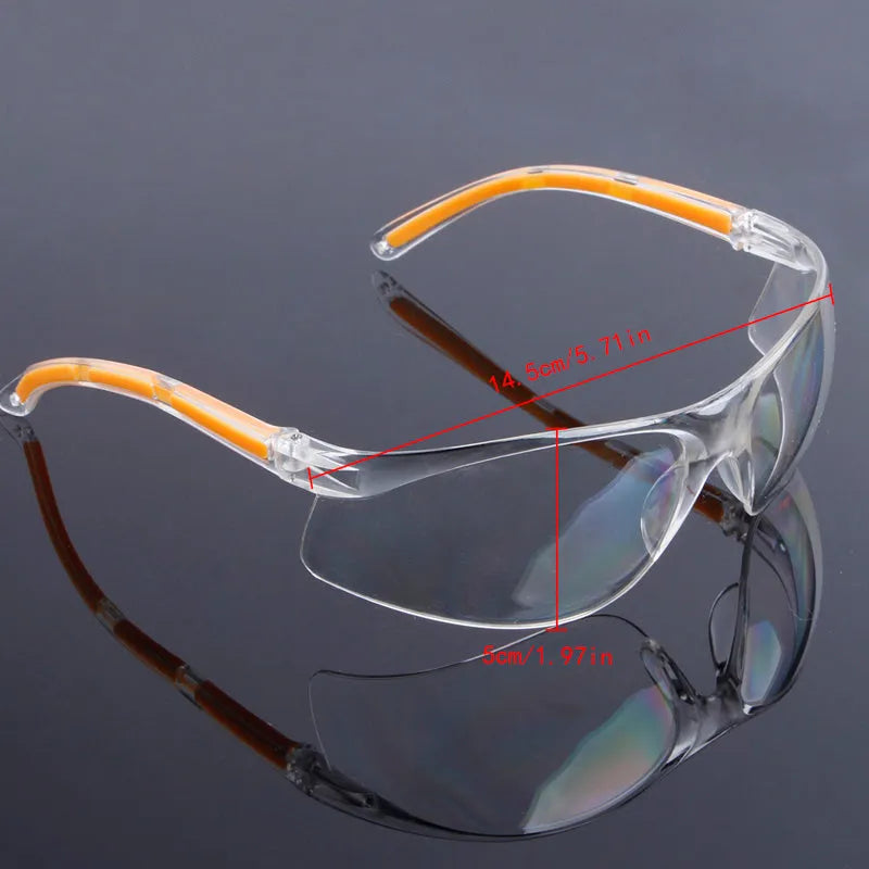 Transparent polycarbonate safety goggles with yellow frame for lab and welding protection.