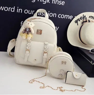 Women's black PU leather backpack, shoulder bag, and card bag set with flower designs.