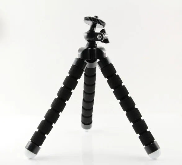 Black flexible octopus tripod with legs wrapped around a pole, holding a smartphone with a clip mount.