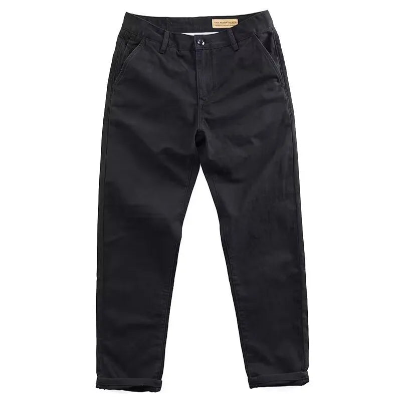 Man wearing slim fit grey micro elastic washed trousers with a straight leg cut for a business casual look.