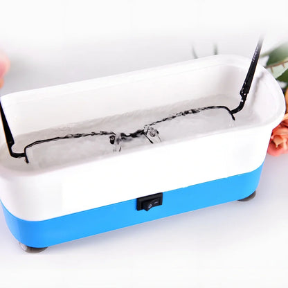 Blue analog ultrasonic cleaner measuring 17x6x8cm with four suction cups and battery compartment