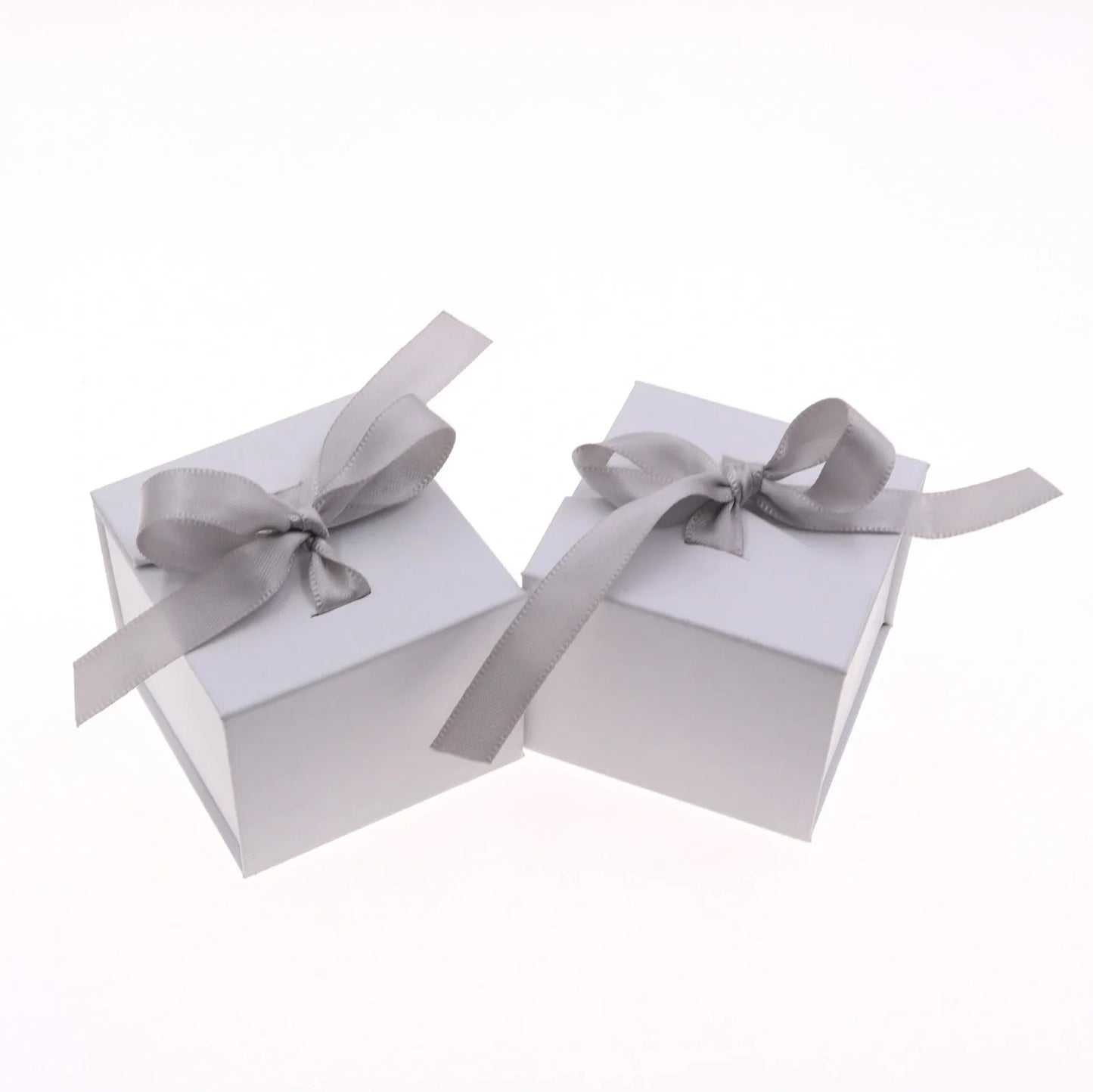 Grey square jewellery box with white ribbon bow measuring 5x5x4cm with sponge-lined interior
