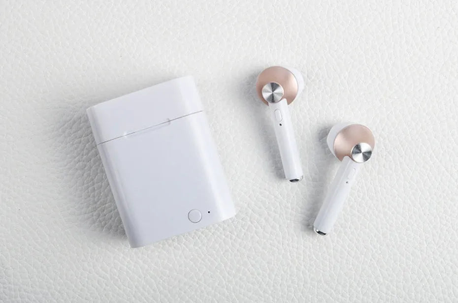 Black wireless sports Bluetooth earbuds showing battery display and placed next to a smartphone.