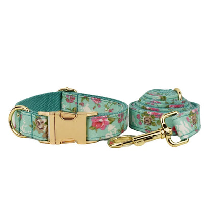 Rose and green cloth dog collar set with detachable bow, matching leash, and vest