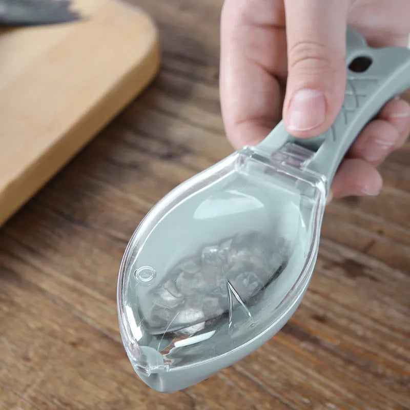 Fish-shaped scaler tool with cover to prevent scale splashing during fish cleaning