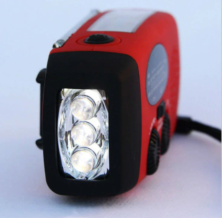 Portable solar and hand-cranked USB charging radio flashlight with LED illumination for outdoor adventures and emergency preparedness