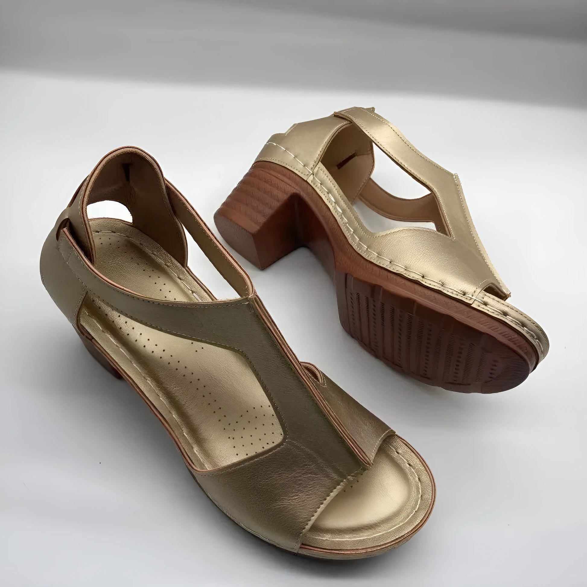 Women's beige peep toe wedge sandals with a buckle strap and low heel on a white background.