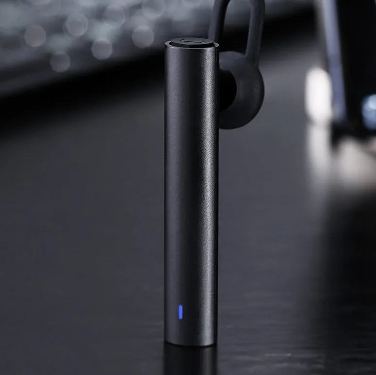 Black wireless Bluetooth headset showing compact 5.6cm design with charging cable