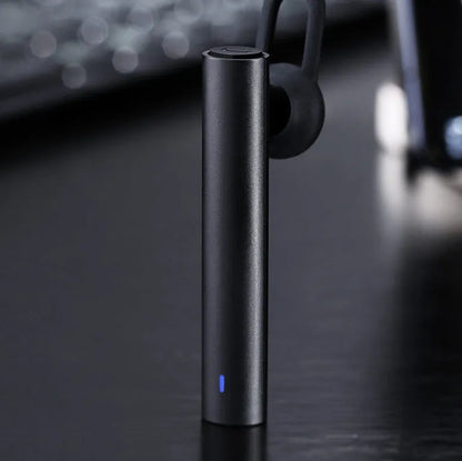 Black wireless Bluetooth headset showing compact 5.6cm design with charging cable