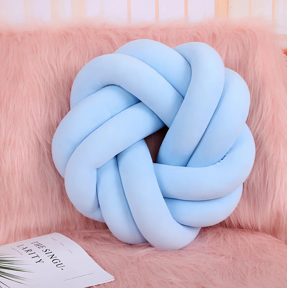 Knotted lumbar pillow with memory foam fill showing adjustable height feature and polyester cover