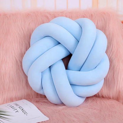 Knotted lumbar pillow with memory foam fill showing adjustable height feature and polyester cover