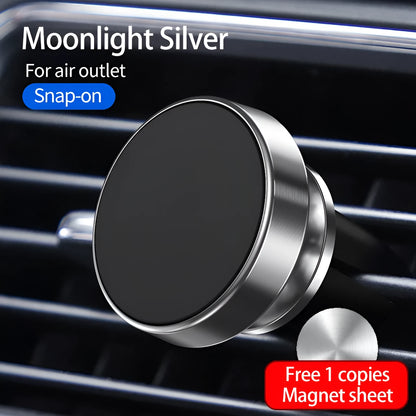 Magnetic car phone holder mounted on dashboard showing smartphone attachment and 360-degree rotation mechanism