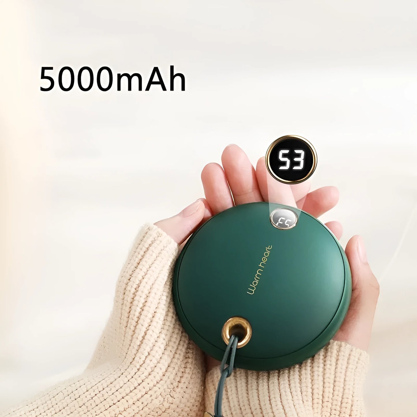 Green portable power bank with digital display showing battery percentage, sized next to a mobile phone for scale