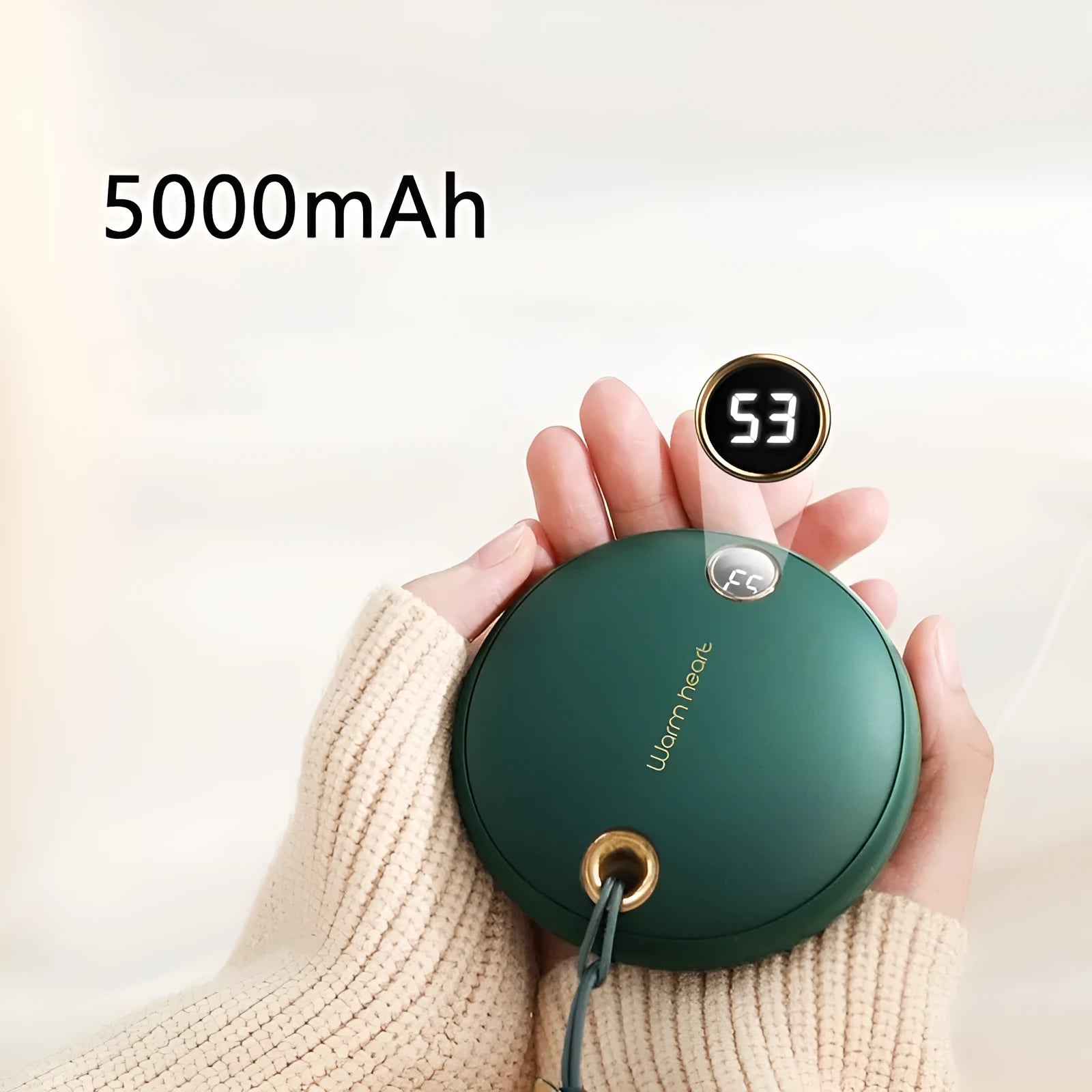 Green portable power bank with digital display showing battery percentage, sized next to a mobile phone for scale