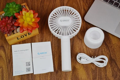 White ORICO FH1 portable USB rechargeable desk and handheld small fan with three speed buttons.