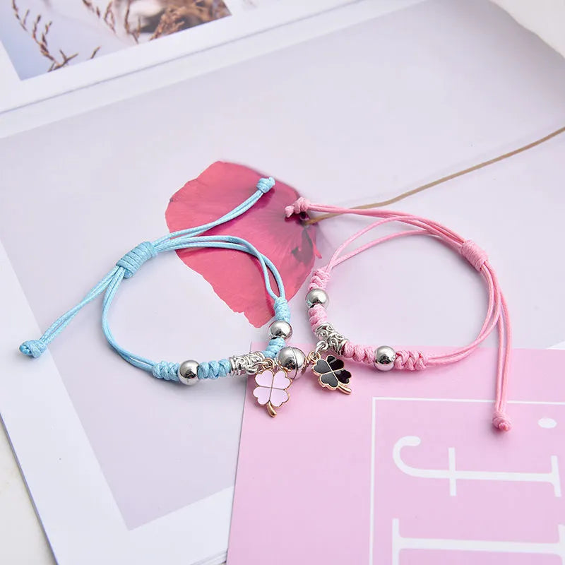 A pair of magnet couple bracelets with a suction clasp, showing various design options like clovers, crowns, and hearts.