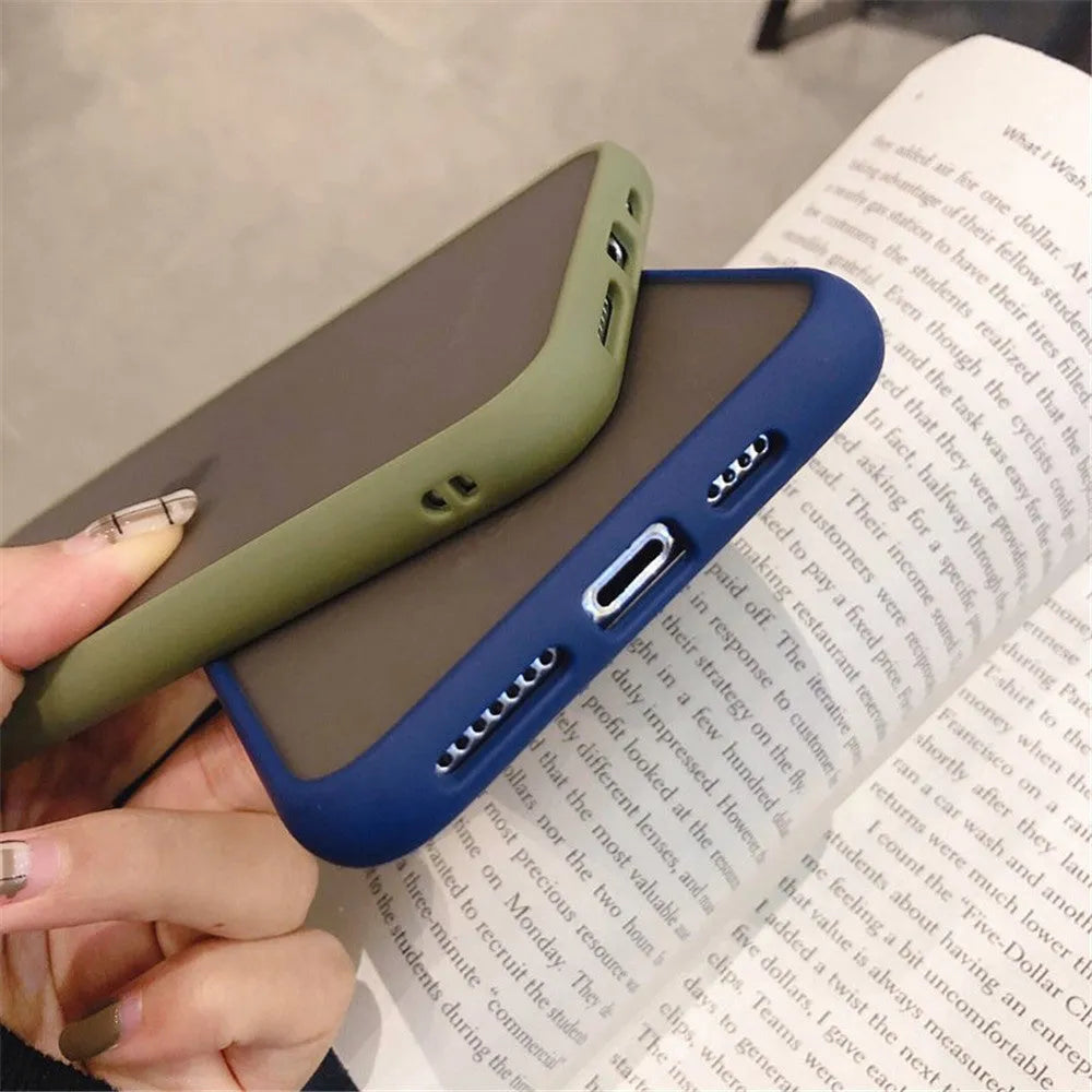 Solid colour silicone shockproof protective case for iPhone models on a table.