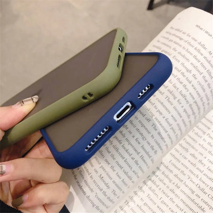 Solid colour silicone shockproof protective case for iPhone models on a table.