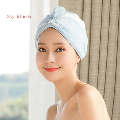 A woman wearing a sky blue microfiber hair dryer cap, with wet hair tucked inside, showing the towel's wrap-around design.