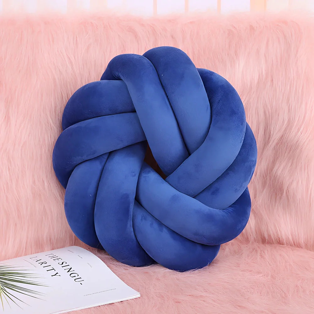 Knotted lumbar pillow with memory foam fill showing adjustable height feature and polyester cover