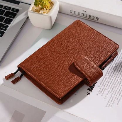 Close-up of a hand-embossed lychee pattern on an off-white A6 cowhide leather notebook with loose-leaf binding.