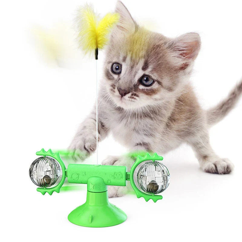 Cat playing with rotating windmill toy featuring luminous balls and suction base