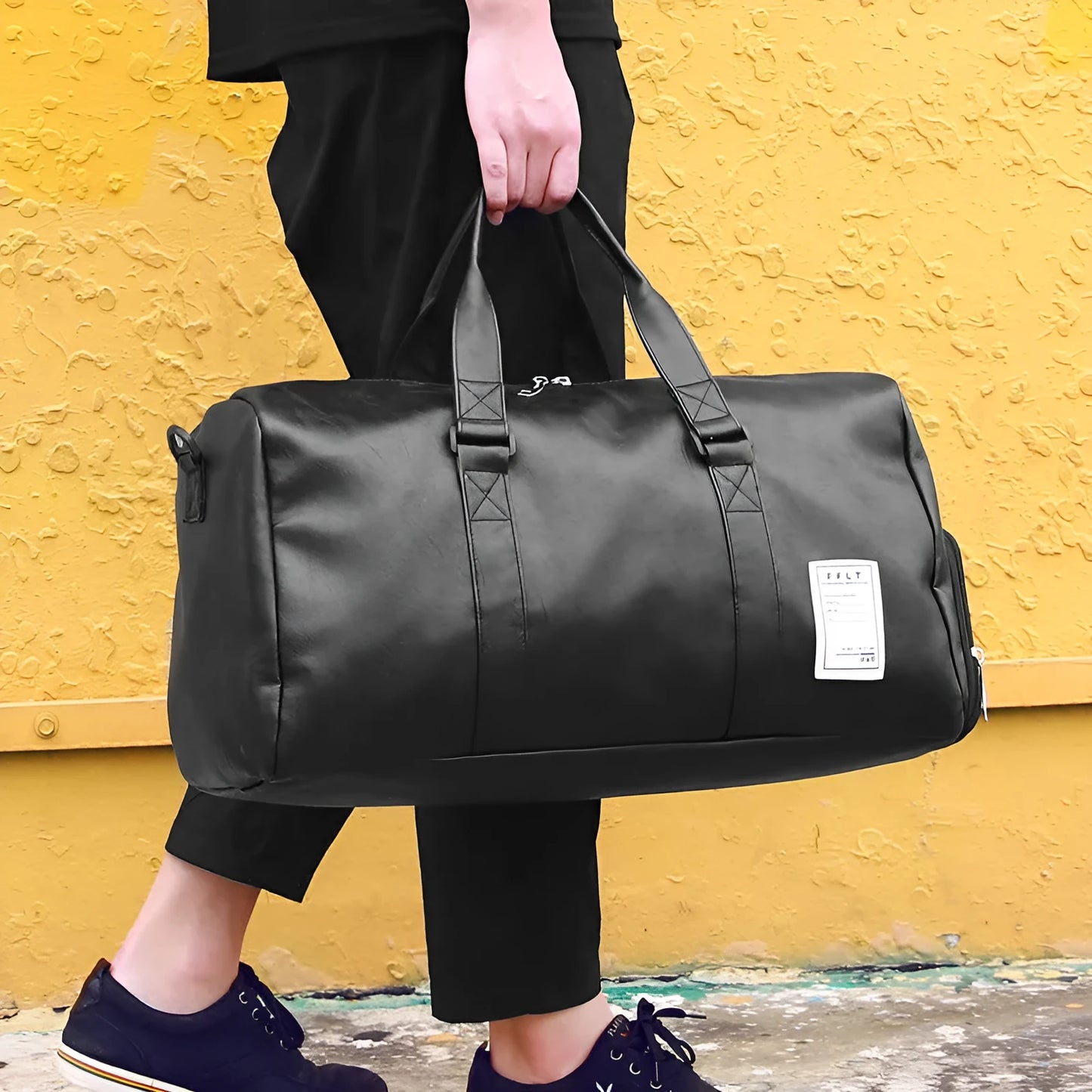 Black waterproof sports bag with separate shoe compartments on the sides, shown with adjustable diagonal strap.