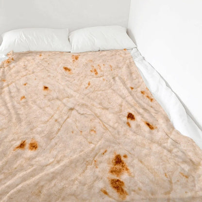 Round flannel burrito blanket with food-themed printing, showing coral fleece texture and wrap-style design