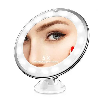 White 10x magnifying LED makeup mirror with flexible gooseneck and suction cup base on a table.