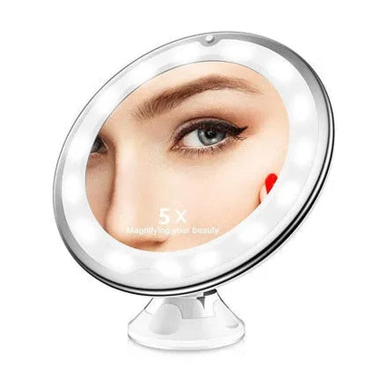 White 10x magnifying LED makeup mirror with flexible gooseneck and suction cup base on a table.