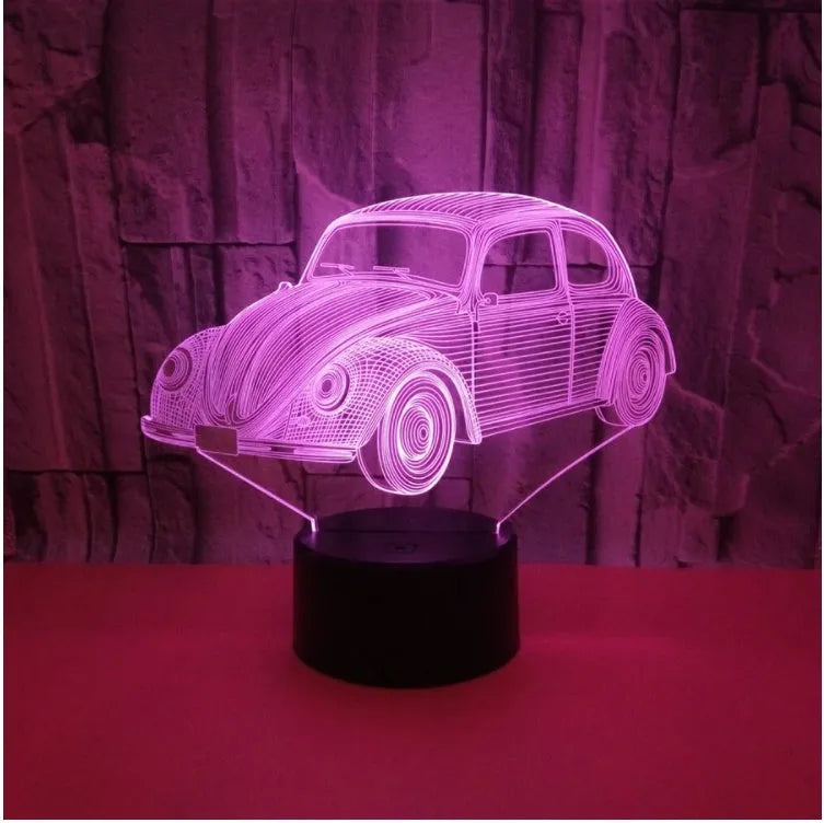 Colourful 3D LED table lamp with remote control and USB cable on wooden desk