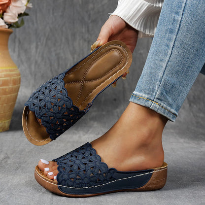 Women's wedge beach slippers with flower cutout design on PVC upper, shown in light brown colour.