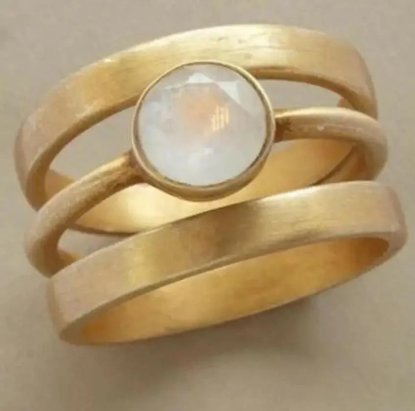 Gold-plated titanium steel ring with geometric design and micro-inlaid white chalcedony gemstone