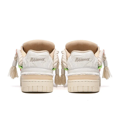 Creamy white old damage lace-up retro skateboard shoes with platform heel on a rubber sole.