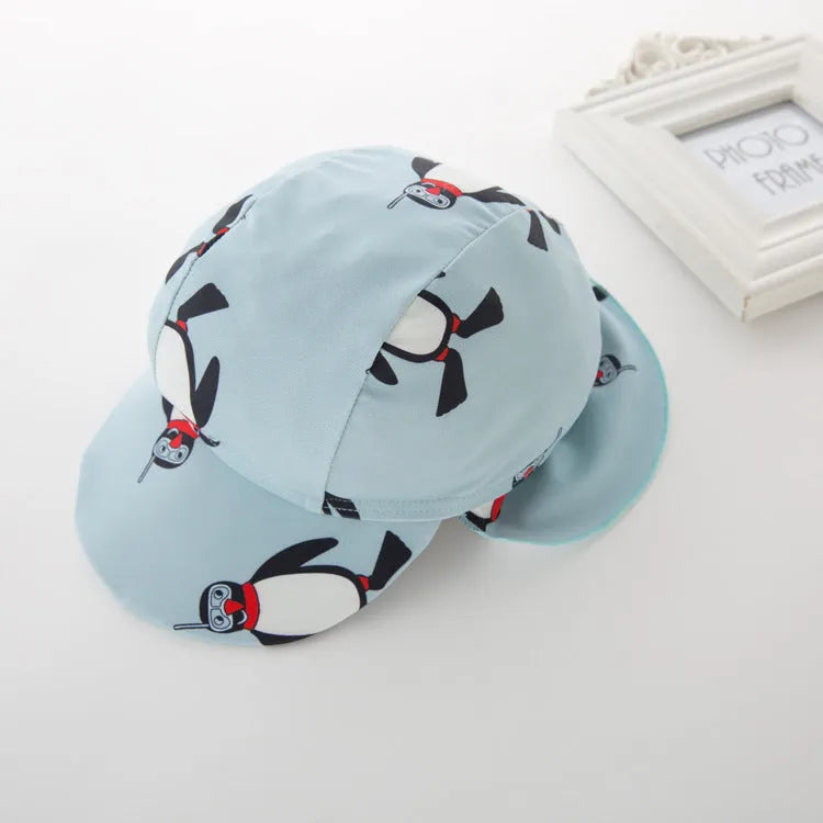 Boy's penguin-print long sleeve swimsuit with matching swimming cap for sun protection