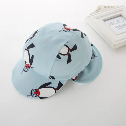 Boy's penguin-print long sleeve swimsuit with matching swimming cap for sun protection