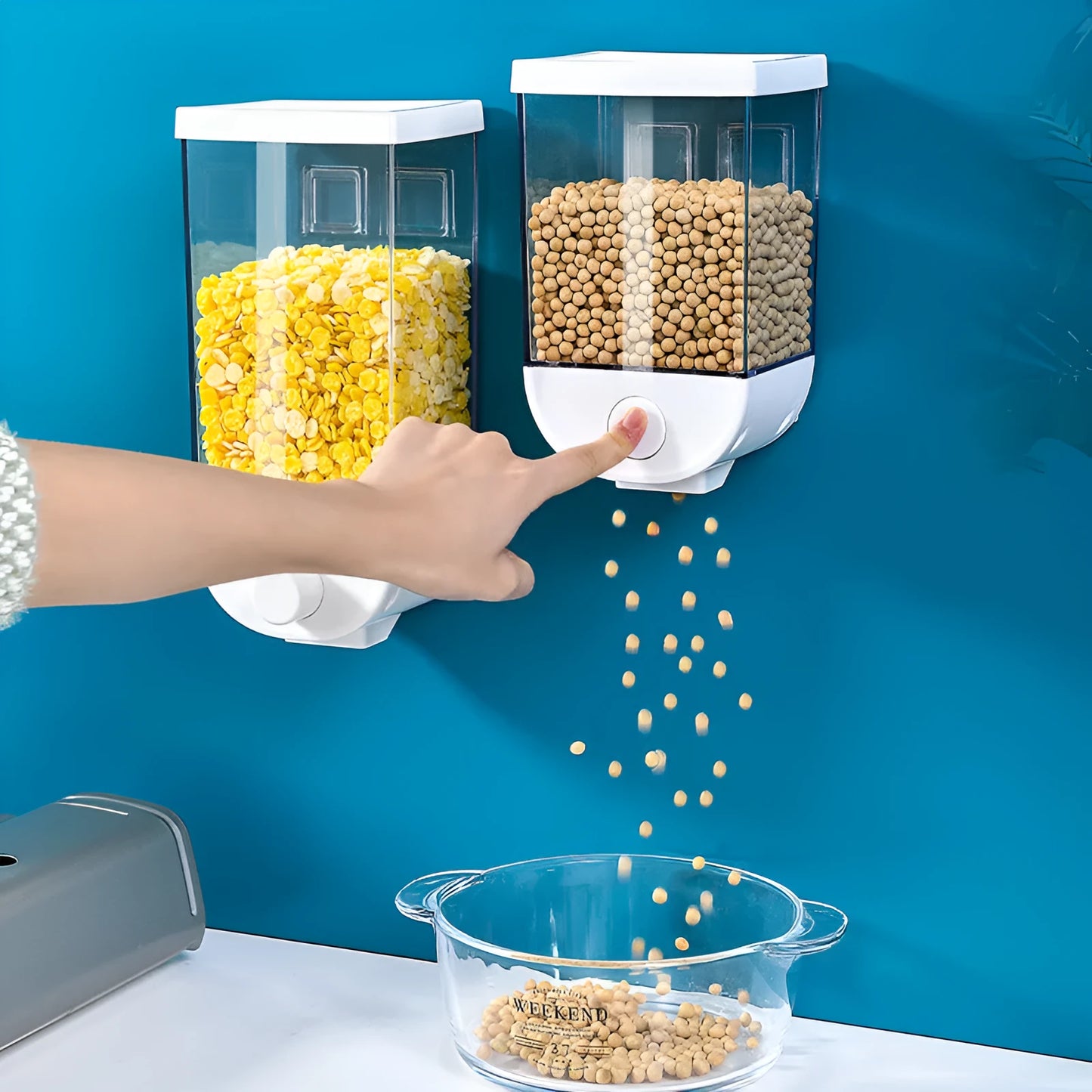 White wall-mountable kitchen food storage box with press lid dispenser, showing transparent body with cereal inside.
