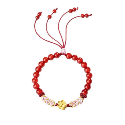 Hand-woven red rope bracelet with crystal peach blossom charm in Chinese style