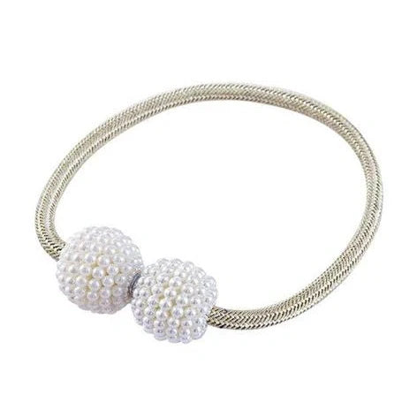 Magnetic curtain tiebacks with white pearl beads and fabric loops holding gathered curtain