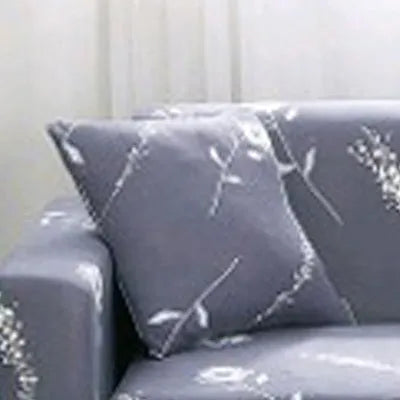 Printed stretchable sofa slipcover with geometric abstraction pattern on a three-seater sofa, showing tight fit and modern design.