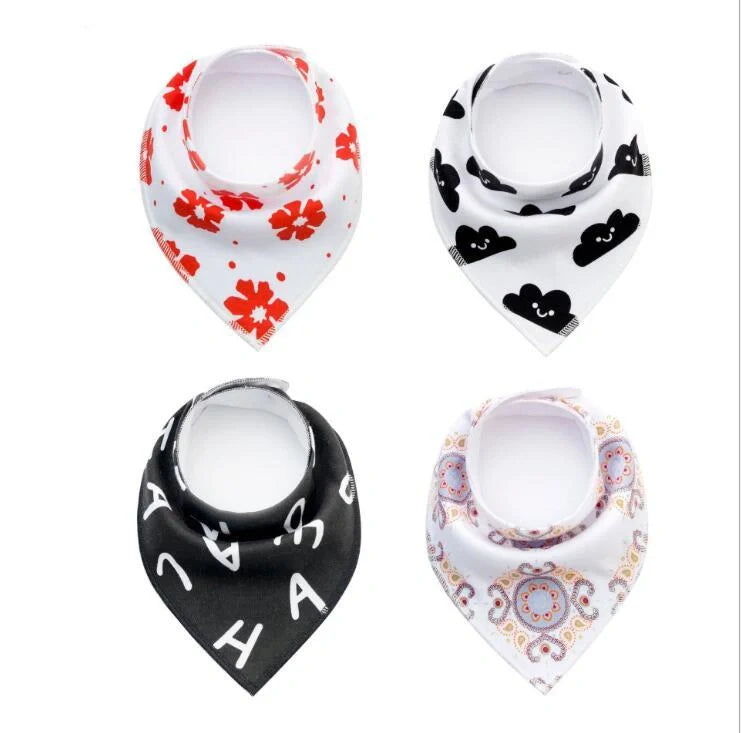 Set of four cotton baby bibs with arrow and wave designs for mess-free feeding