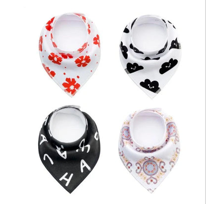 Set of four cotton baby bibs with arrow and wave designs for mess-free feeding