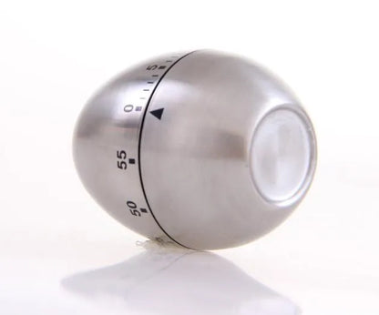 Stainless steel egg-shaped mechanical kitchen timer on a countertop.