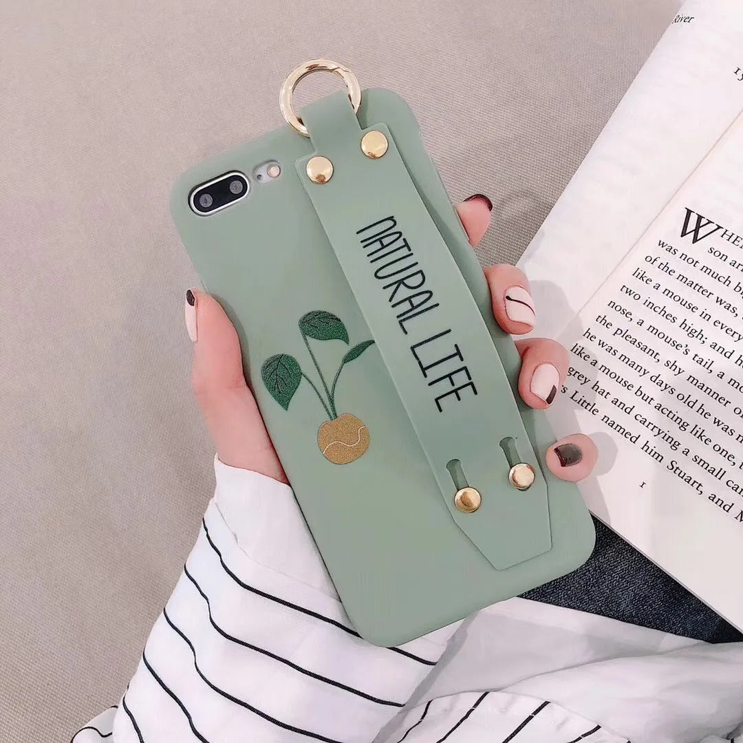 Green iPhone case with graffiti design and integrated wristband holder on back cover